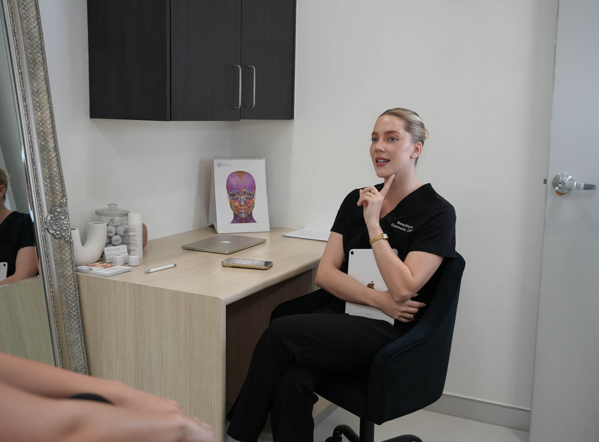 Chelsea talking through facial assessment findings at the consultation desk